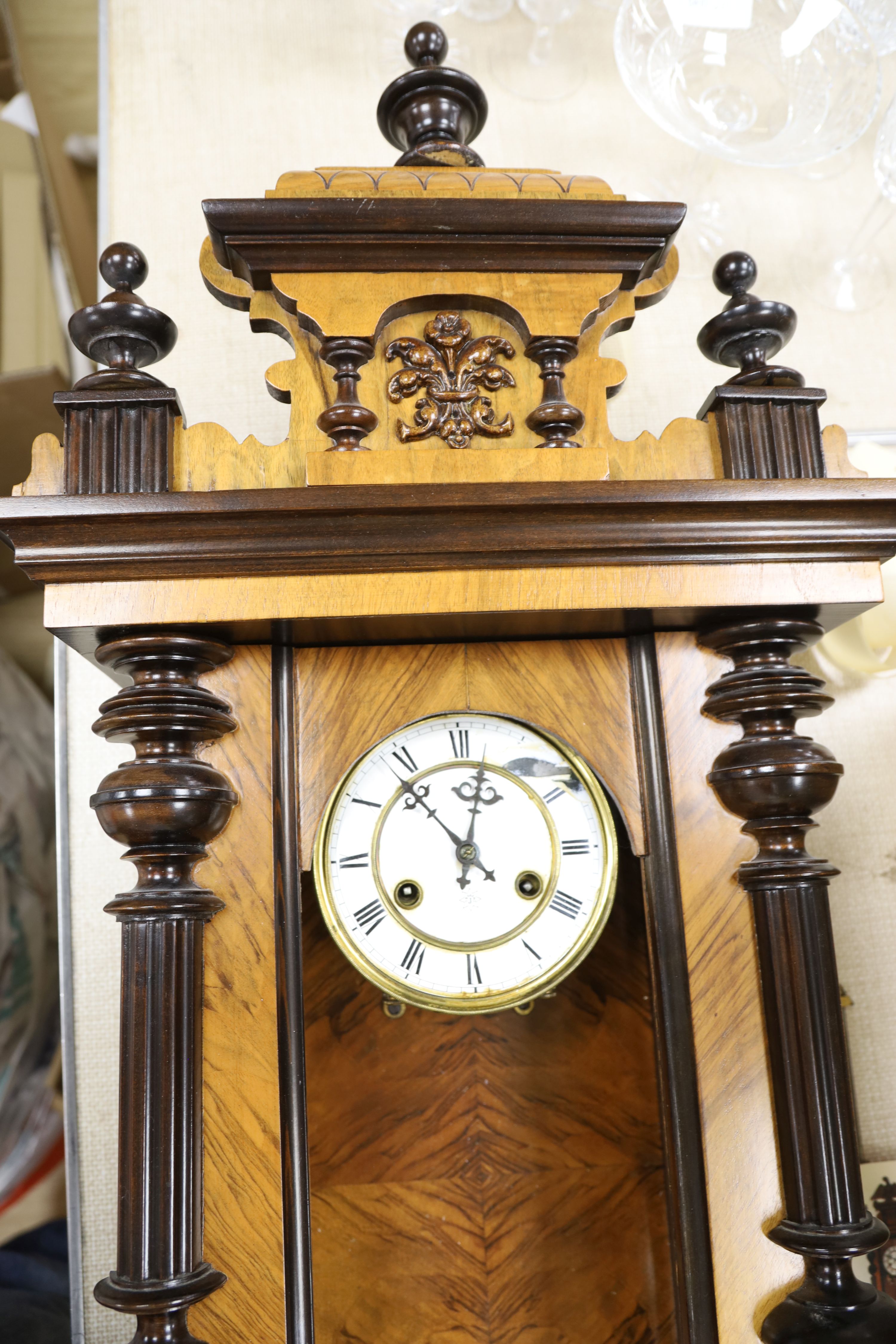 A 19th century German walnut wall clock, length 102cm
